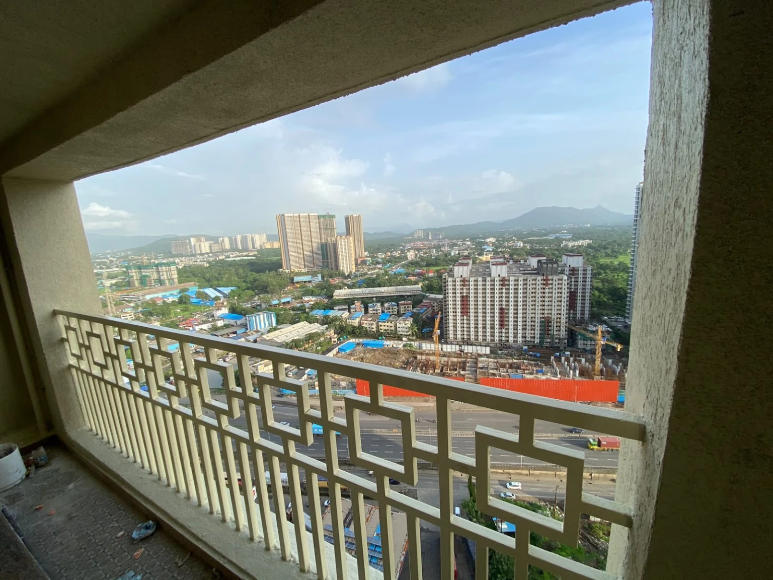 Decorative balcony safety grill overlooking a high-rise city view