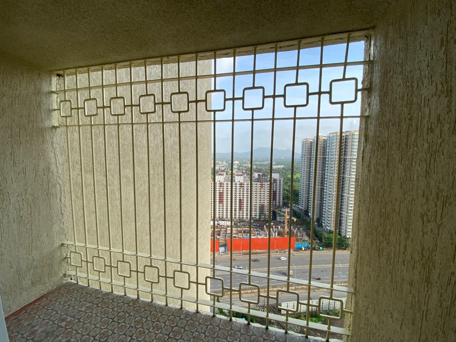 Decorative metal balcony safety grill installed on a high-rise apartment opening
